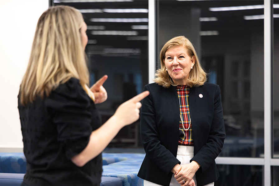 Secretary Guidera listening to someone talk