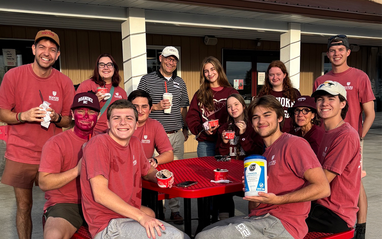 Students posing at table at football game