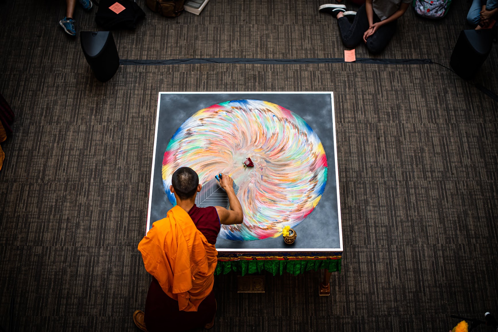 Tibetan Monks sweep away a mandala of compassion for the world.