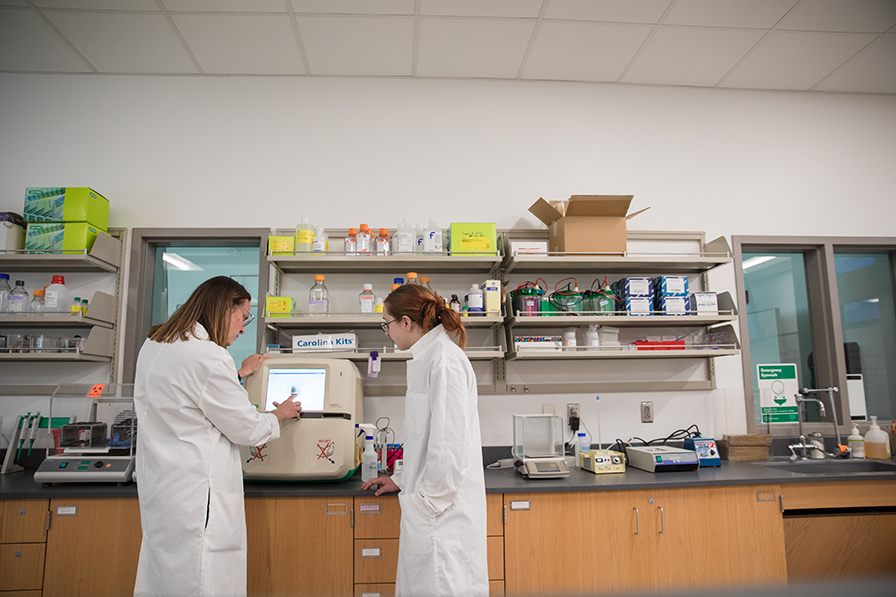student and professor in lab