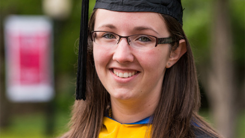 Kayla Mullins in cap and gown on her graduation day