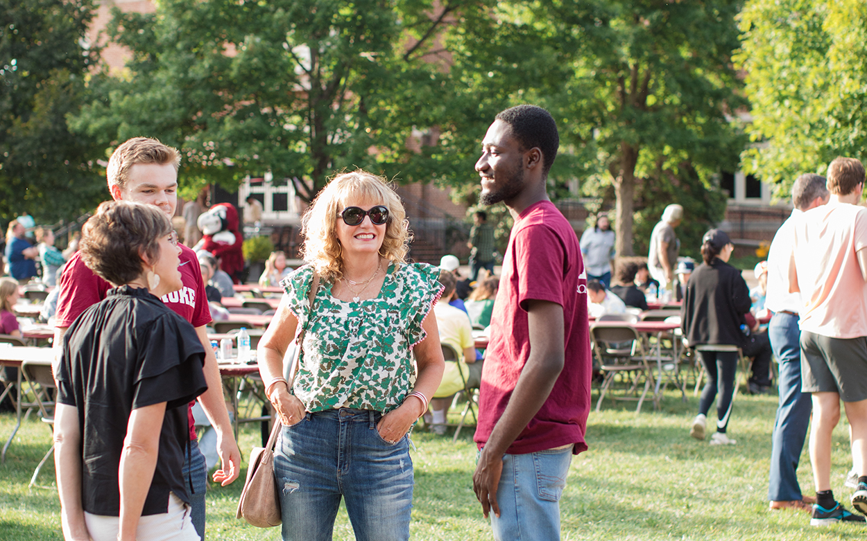 Parents and students talking to Rev. Kelly Sushok