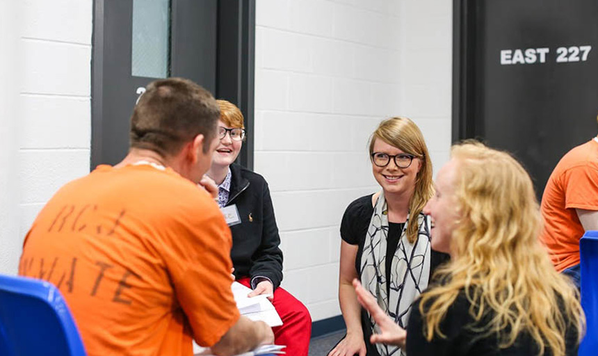 Students and inmates talking during a joint class event