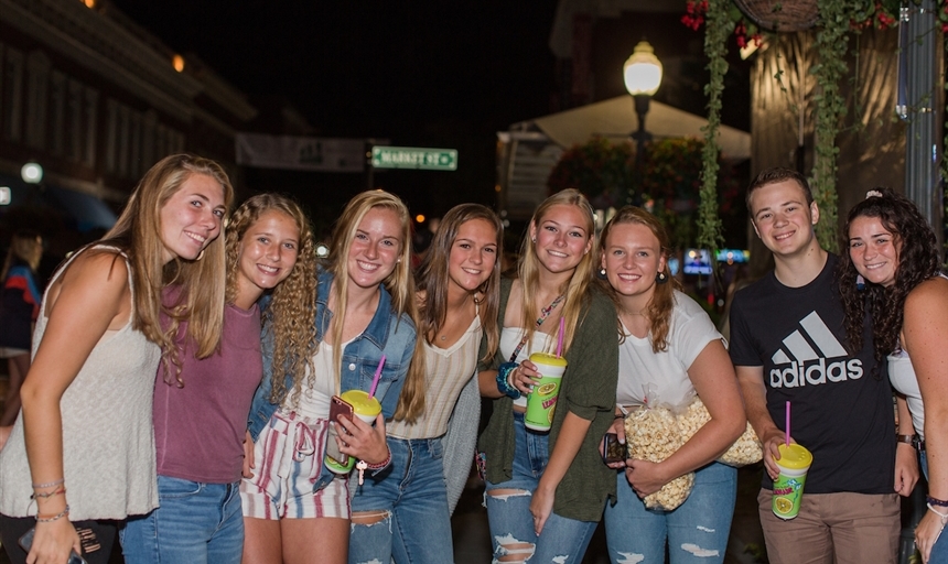 group of students with snacks posing together at an orientation event