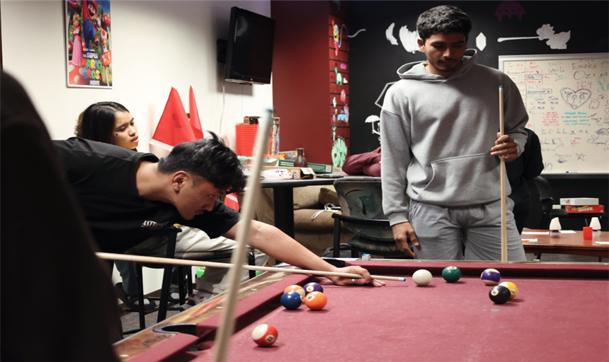 photo of boys playing pool in the gameroom