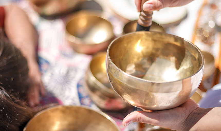 Hands holding a tibetan singing bowl