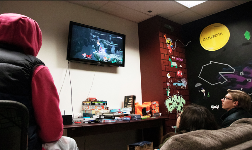 Students playing video games on a TV 