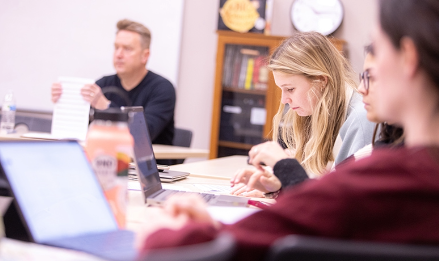 Students working on laptops in a classroom