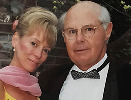 Headshot of a man in tuxedo and woman in pink dress