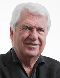 Headshot of a white-haired man in a black button-down shirt.