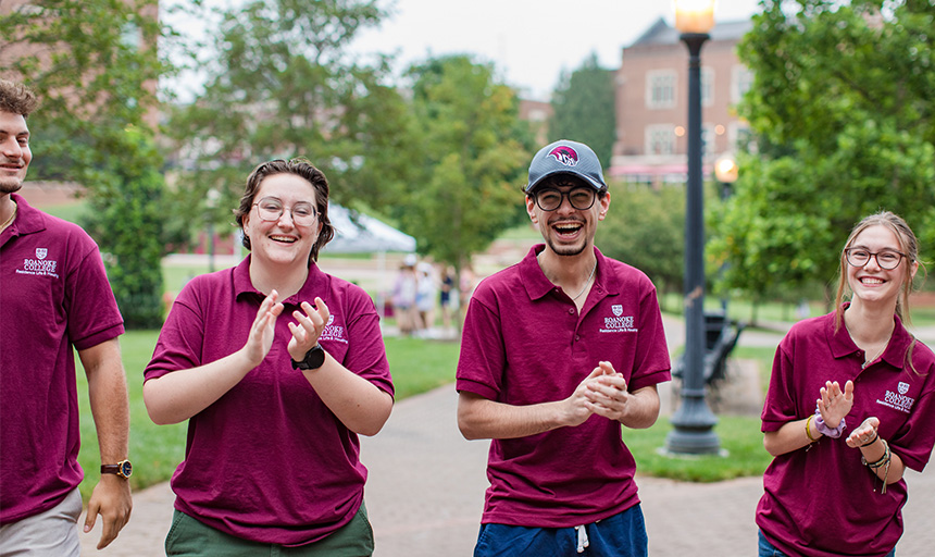 Student resident advisors smile and cheer