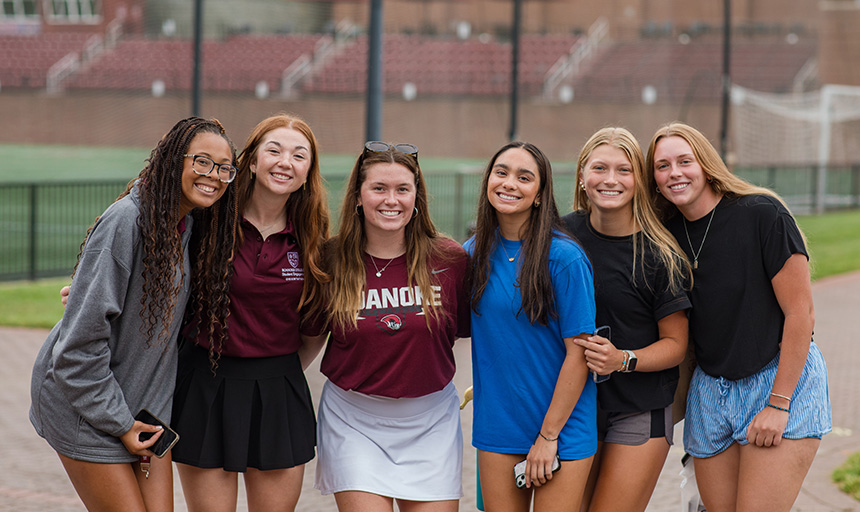 A group of students smile for a photo