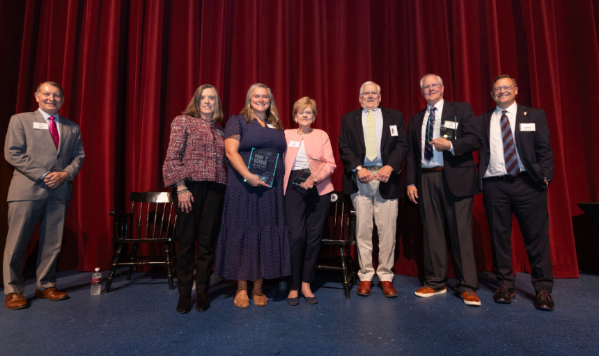 Emcee John Carlin, Roanoke College President Frank Shushok and Hollins University Executive Vice President and COO Kerry Edmonds stand on stage with the members of the Kendig family who received Legacy Awards during the award ceremony. 