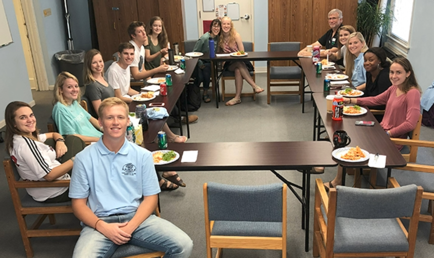 Students eating pizza together